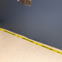 Floor message tape indicating hard hat area