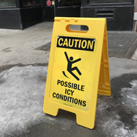 Icy conditions warning sign for sidewalk