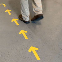 Yellow arrow signs for floor