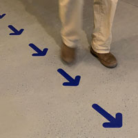 Blue arrow markers for floor